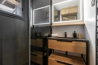 a bathroom with a sink and a mirror at Kinabalu - Vue Mt Blanc Range Les houches center in Les Houches