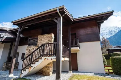 a house with a staircase in front of it at Kinabalu - Vue Mt Blanc Range Les houches center in Les Houches