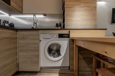 a washing machine in a kitchen next to a counter at Kinabalu - Vue Mt Blanc Range Les houches center in Les Houches