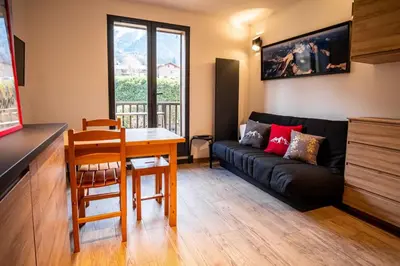 a living room with a couch and a table at Kinabalu - Vue Mt Blanc Range Les houches center in Les Houches