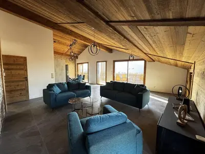 a living room with two blue couches and a table at Appartement de standing, au pied des pistes avec parking et WIFI, Les Carroz d'Arâches - FR-1-572-280 in Arâches-la-Frasse