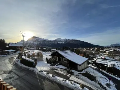 a snow covered city with a mountain in the background at Appartement de standing, au pied des pistes avec parking et WIFI, Les Carroz d'Arâches - FR-1-572-280 in Arâches-la-Frasse