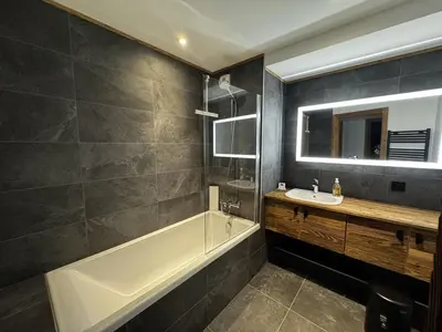 a bathroom with a bath tub and a sink at Appartement de standing, au pied des pistes avec parking et WIFI, Les Carroz d'Arâches - FR-1-572-280 in Arâches-la-Frasse