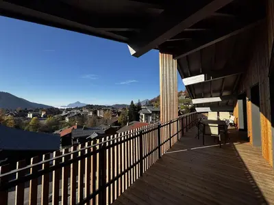 a balcony of a house with a view of a city at Appartement de standing, au pied des pistes avec parking et WIFI, Les Carroz d'Arâches - FR-1-572-280 in Arâches-la-Frasse