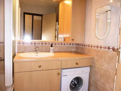 a bathroom with a sink and a washing machine at Résidence Bel'aval - Bel Aval 195 MAE-6364 in Les Contamines-Montjoie