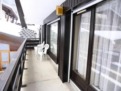 a balcony with chairs and windows on a train at Résidence Bel'aval - Bel Aval 195 MAE-6364 in Les Contamines-Montjoie