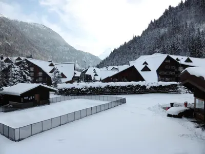 a village covered in snow with mountains in the background at Résidence Bel'aval - Bel Aval 195 MAE-6364 in Les Contamines-Montjoie