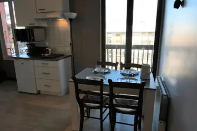 a kitchen with a table with four chairs and a kitchen with at Résidence Les Bruyeres - Bruyères 4 MAE-6354 in Saint-Gervais-les-Bains
