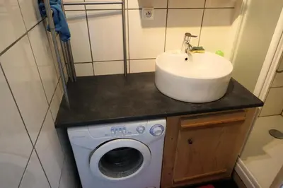 a bathroom with a sink and a washing machine at Résidence Les Bruyeres - Bruyères 4 MAE-6354 in Saint-Gervais-les-Bains