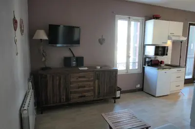 a kitchen with a tv on top of a wooden cabinet at Résidence Les Bruyeres - Bruyères 4 MAE-6354 in Saint-Gervais-les-Bains