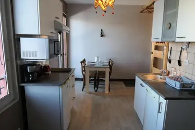a kitchen with a table and a kitchen with white cabinets at Résidence Les Bruyeres - Bruyères 4 MAE-6354 in Saint-Gervais-les-Bains