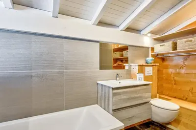 a bathroom with a sink and a toilet at La Suite Darray - Welkeys in Megève