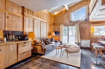 a living room with a couch and a table at La Suite Darray - Welkeys in Megève