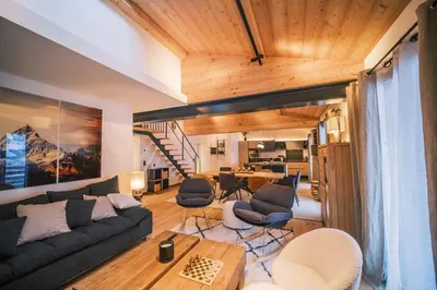 a living room with a couch and chairs and a table at Loft Zodiak -Centre Ville 4 Chambres Vue in Les Houches