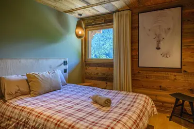 a bedroom with a bed and a window at CHALET UTOPIA in Saint-Gervais-les-Bains