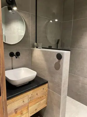 a bathroom with a sink and a mirror at CHALET UTOPIA in Saint-Gervais-les-Bains