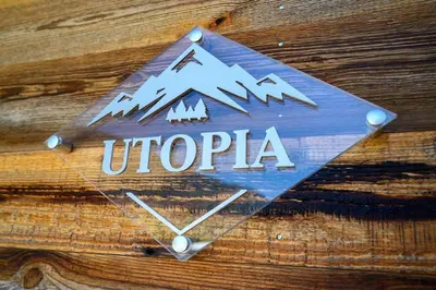 a sign that says uprica on a wooden wall at CHALET UTOPIA in Saint-Gervais-les-Bains