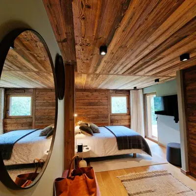 a bedroom with a large mirror and a bed at CHALET UTOPIA in Saint-Gervais-les-Bains