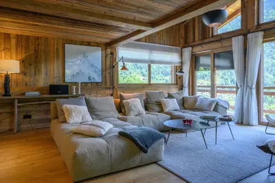 a living room with a couch and a table at CHALET UTOPIA in Saint-Gervais-les-Bains