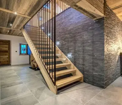 a loft with wooden ceilings and a desk and a television at Chalet de L'Ours Blanc in Saint-Gervais-les-Bains