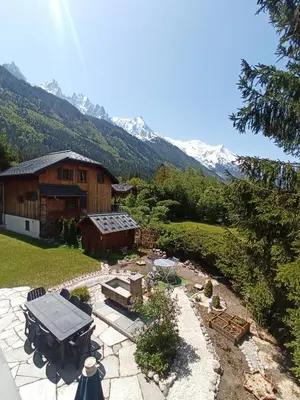 a backyard with a building and a fire pit and a house at le jardin de talèfre in Chamonix-Mont-Blanc