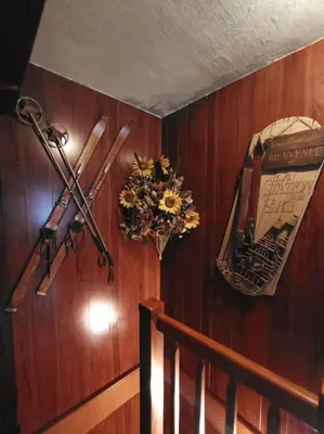 a wooden wall with skis and a vase of flowers at le jardin de talèfre in Chamonix-Mont-Blanc