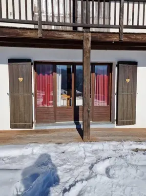 a building with windows with snow in front of it at Appartement - Vue Mont-Blanc in Cordon
