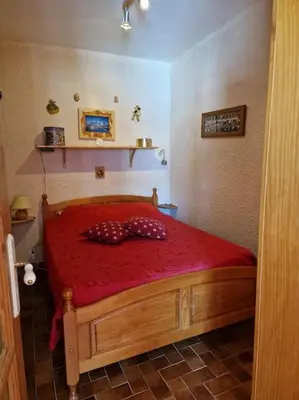 a bedroom with a red bed in a room at Appartement - Vue Mont-Blanc in Cordon
