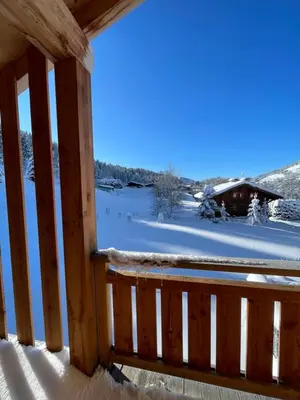 a view from the balcony of a cabin in the snow at Chalet Clos du Nant Megève in Demi-Quartier