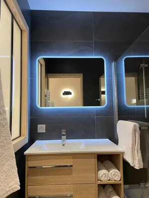a bathroom with a sink and a mirror at Chalet Clos du Nant Megève in Demi-Quartier