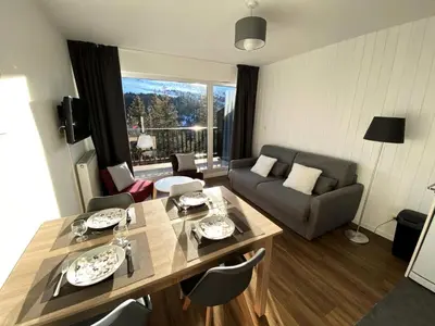 a living room with a table and a couch at Résidence Les Pleiades - Appartement rénové · Centre station · Balcon · Parking couvert MAE-8234 in Magland