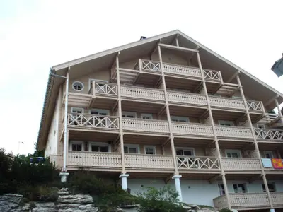 a building with balconies on the side of it at Résidence Chateaux De Crans - Studio lumineux · Balcon MAE-8264 in Magland