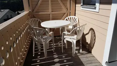 a table and four chairs on a balcony at Résidence Chateaux De Crans - Studio lumineux · Balcon MAE-8264 in Magland