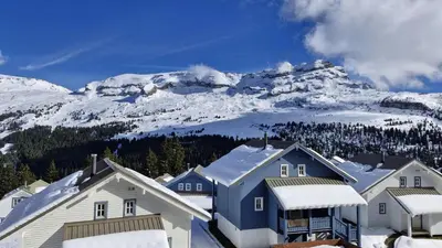 a group of houses in front of a snow covered mountain at Résidence Chateaux De Crans - Studio lumineux · Balcon MAE-8264 in Magland