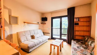 a living room with a couch and a large window at Résidence Andromede - Studio agréable avec casier à ski · Proche des pistes · Balcon MAE-4274 in Magland