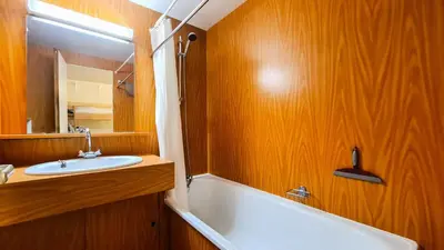 a bathroom with a tub and a sink and a mirror at Résidence Andromede - Studio agréable avec casier à ski · Proche des pistes · Balcon MAE-4274 in Magland
