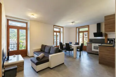 a living room with a couch and a table at Résidence du Parc - Happy Rentals in Saint-Gervais-les-Bains