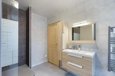 a bedroom with a large bed and a large window at Résidence du Parc - Happy Rentals in Saint-Gervais-les-Bains