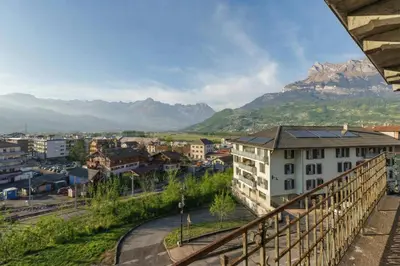 a view from a balcony of a city in the snow at Résidence du Parc - Happy Rentals in Saint-Gervais-les-Bains