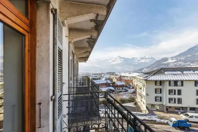 a view from a balcony with snow covered mountains at Résidence du Parc - Happy Rentals in Saint-Gervais-les-Bains