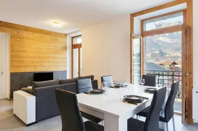 a large building in the snow with snow at Résidence du Parc - Happy Rentals in Saint-Gervais-les-Bains