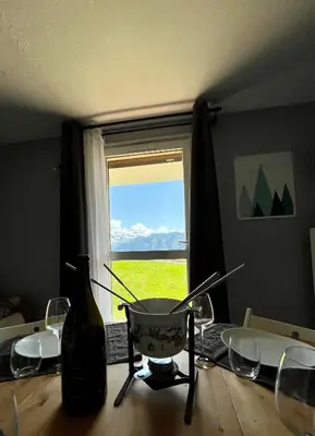 a table with a bowl on top of a table with a window at Samoens 1600, ski au pied in Samoëns