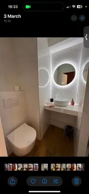 a bathroom with a white toilet and a mirror at Le Sasha in Chamonix-Mont-Blanc
