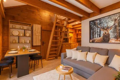 a living room with a couch and a table at Mazot cozy chalet spirit in Chamonix in Chamonix-Mont-Blanc