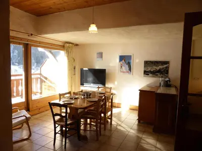 a dining room with a table and chairs and a television at Résidence Berangere - Bérangère 33 MAE-0704 in Les Contamines-Montjoie