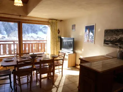 a kitchen and dining room with a table and a television at Résidence Berangere - Bérangère 33 MAE-0704 in Les Contamines-Montjoie