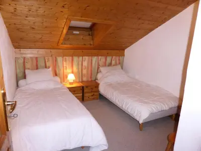 two beds in a room with wooden ceilings at Résidence Berangere - Bérangère 33 MAE-0704 in Les Contamines-Montjoie