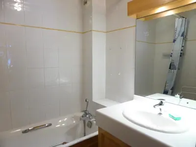 a bathroom with a sink and a tub and a mirror at Résidence Berangere - Bérangère 33 MAE-0704 in Les Contamines-Montjoie