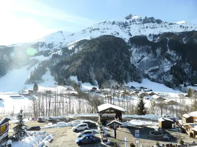 a snowy mountain with cars parked in a parking lot at Résidence Berangere - Bérangère 33 MAE-0704 in Les Contamines-Montjoie