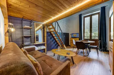 a living room with a couch and a table at Superbe appartement hyper-centre in Chamonix-Mont-Blanc